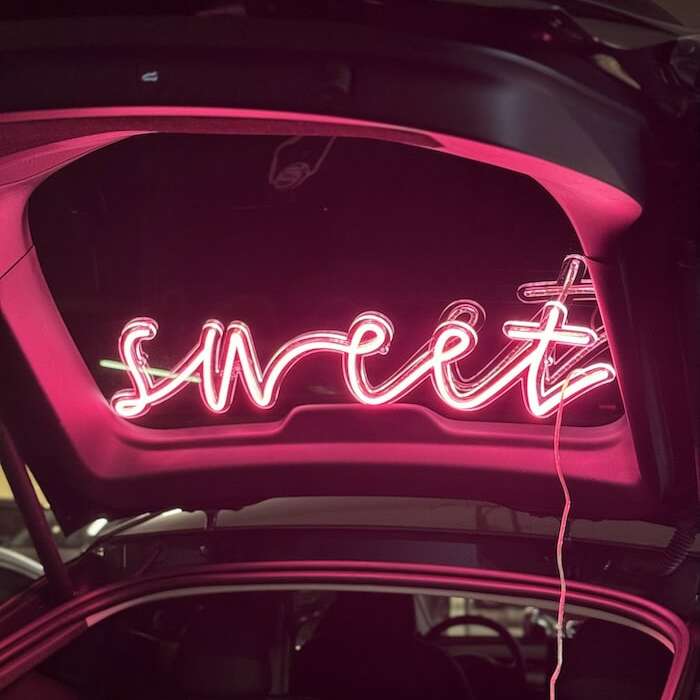 sweet pink neon sign in trunk